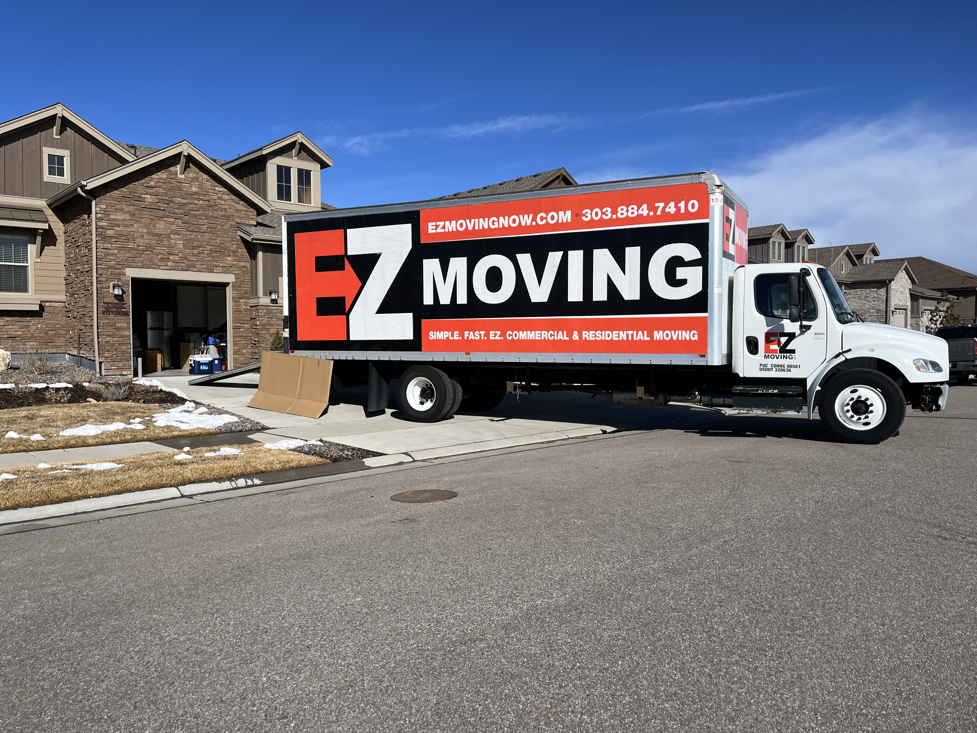 EZ Moving truck parked in driveway of house ready for the movers