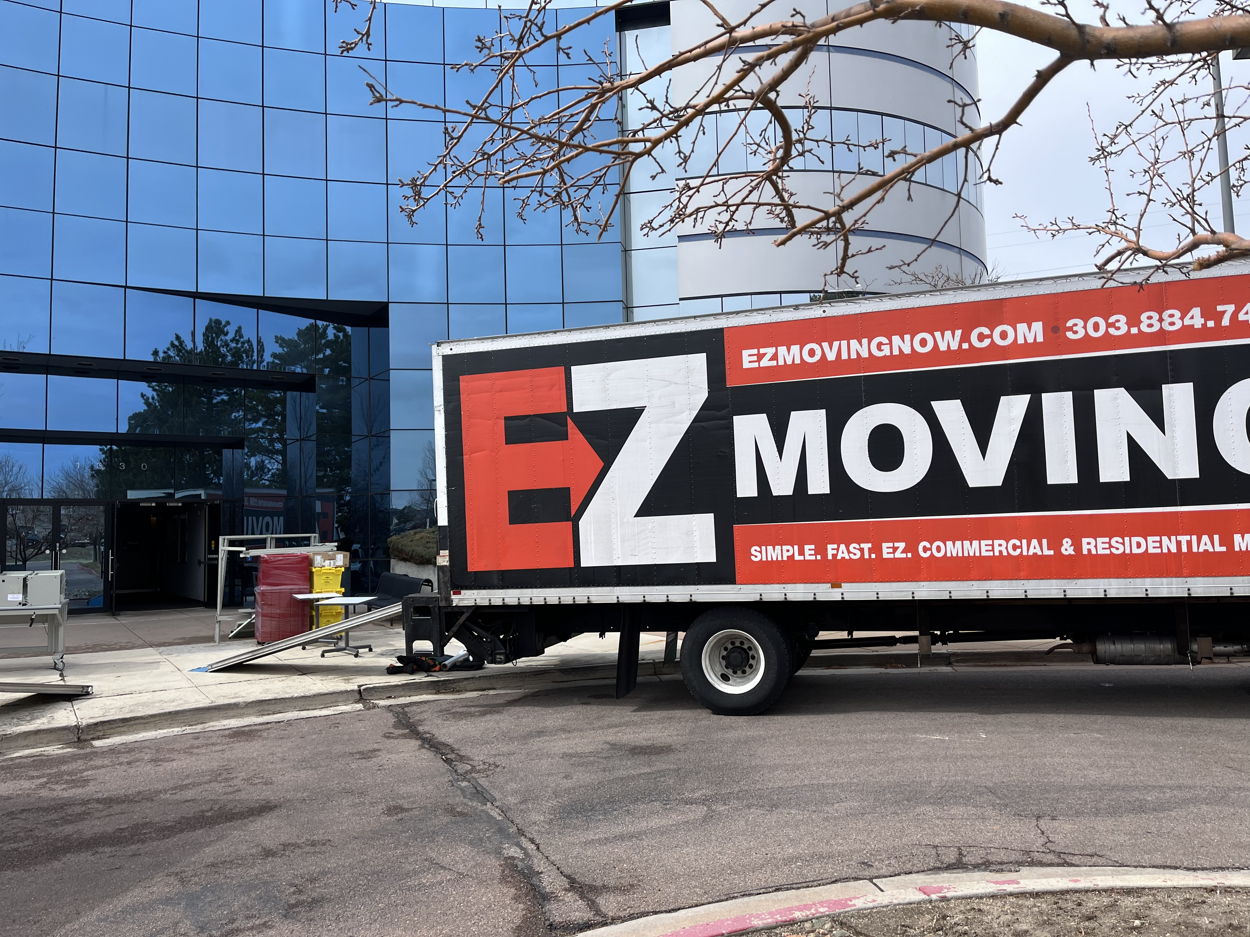 EZ Moving truck parked in front of an office building