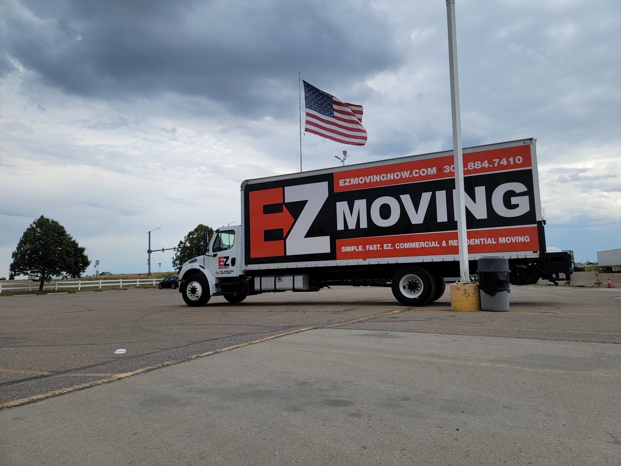 EZ Moving truck driving down a Denver, Colorado road