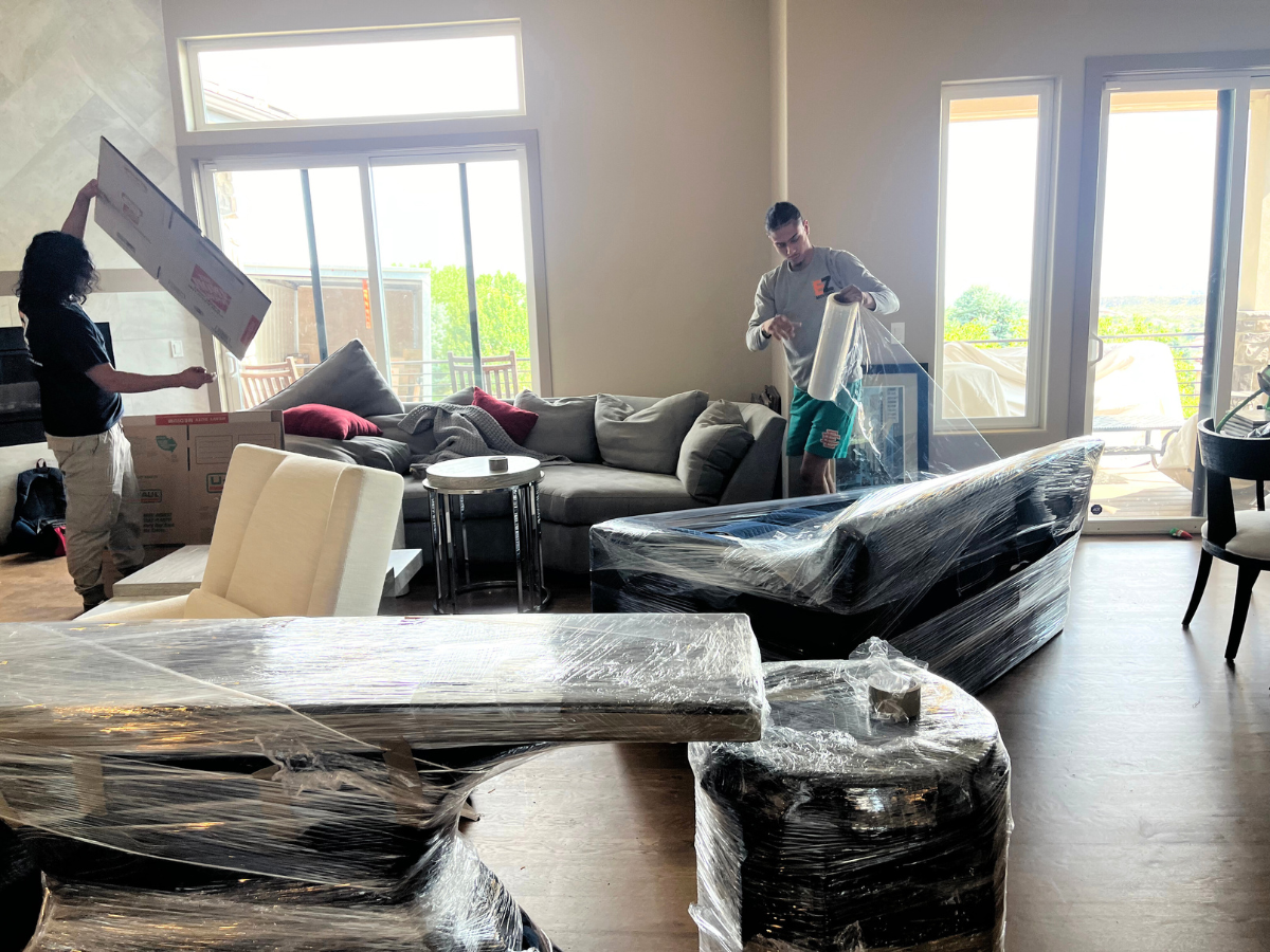 EZ Moving employees packing up the living room of a house