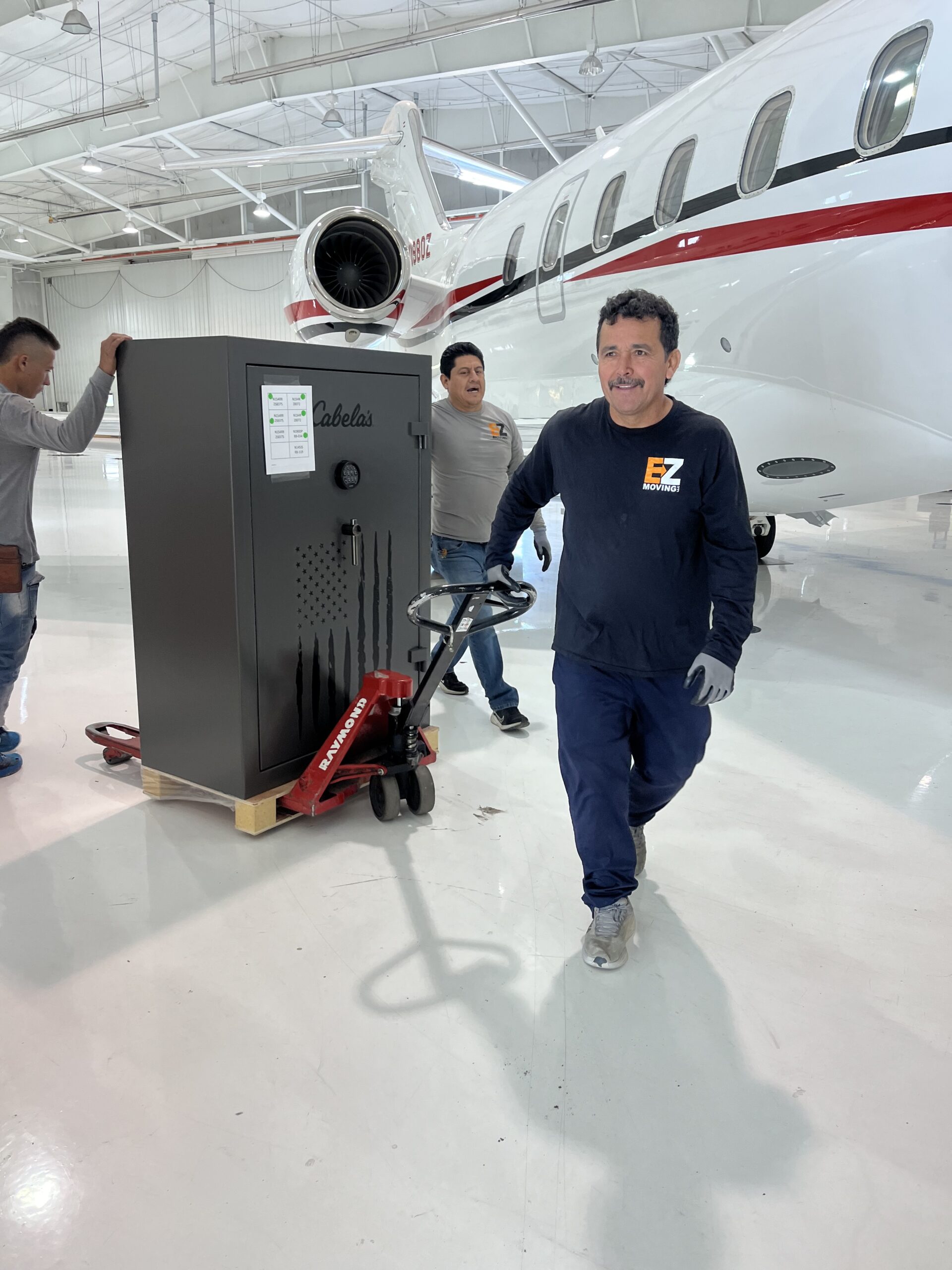 EZ Movers pulling a safe through a private jet hanger in Denver, Colorado