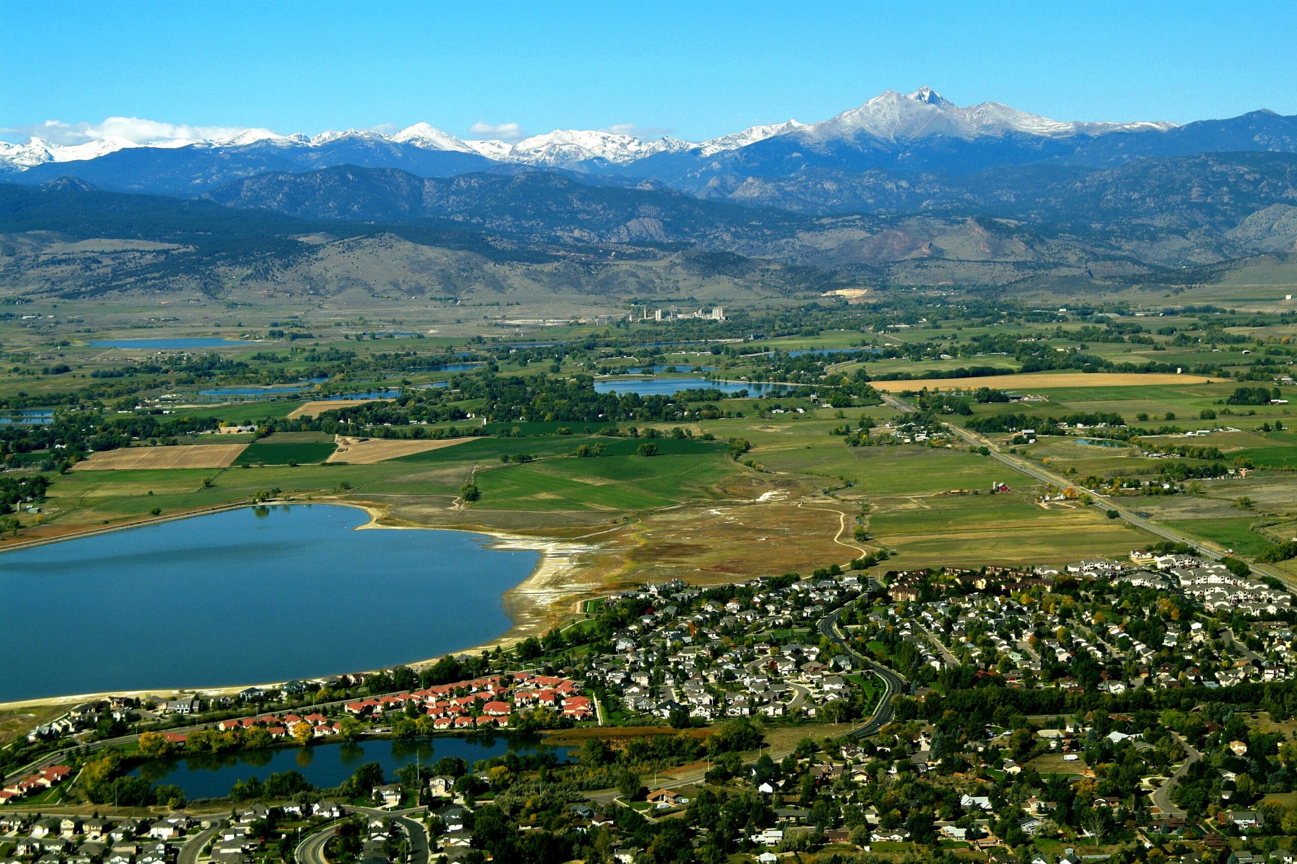 Aerial image of Longmont Colorado with lake and mountains