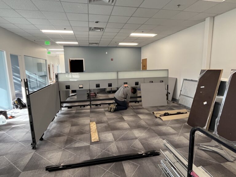 EZ Moving worker breaking down office furniture
